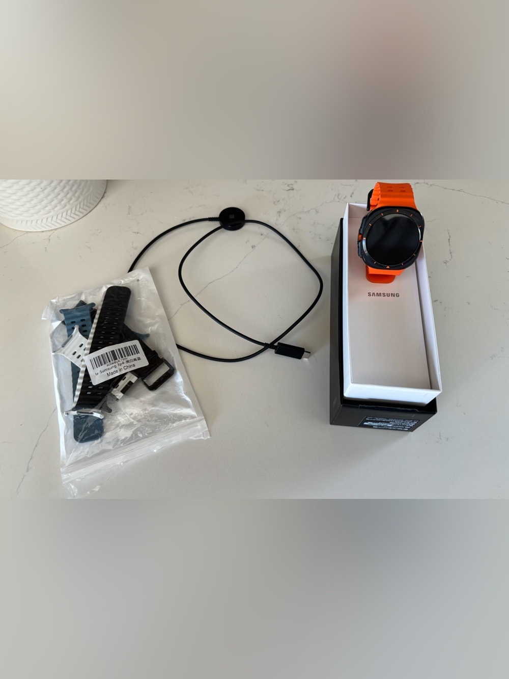 Samsung Galaxy Watch Ultra  with Bright Orange Perforated Sport Band